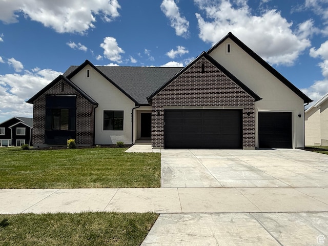 4111 N Ophir Dr, Eagle Mountain, UT 84005 - french country home with a garage, concrete driveway, a front yard, brick siding, and stucco siding