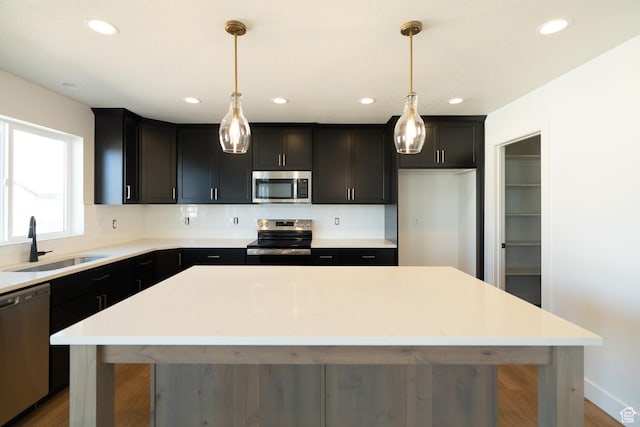 4111 N Ophir Dr, Eagle Mountain, UT 84005 - kitchen featuring stainless steel appliances, a sink, a kitchen island, backsplash, and recessed lighting