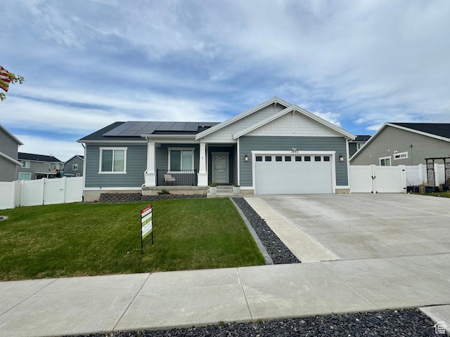 single story home featuring a porch, a gate, concrete driveway, solar panels, and an attached garage