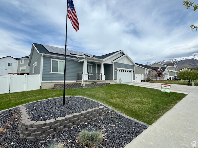 1033 E Bigelow Ave, Layton, UT 84040 - single story home featuring a porch, a front lawn, roof mounted solar panels, and a gate