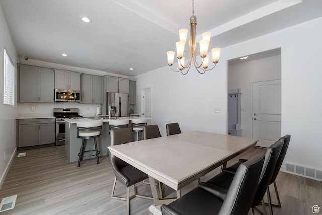 1033 E Bigelow Ave, Layton, UT 84040 - dining area with visible vents, a notable chandelier, light wood-style floors, and recessed lighting