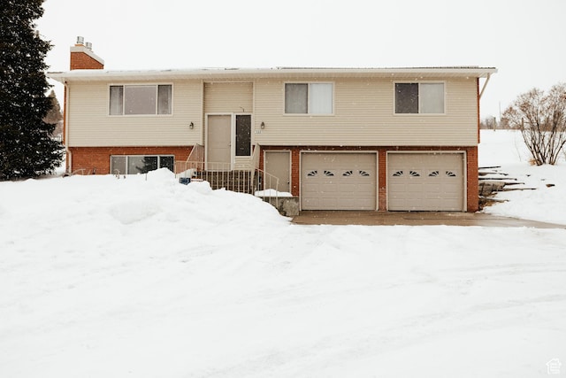 322 Bailey Rd, Soda Springs, ID 83276 - split foyer home featuring a garage, a chimney, brick siding, and entry steps