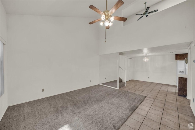 below grade area featuring ceiling fan, light tile patterned floors, and a chandelier