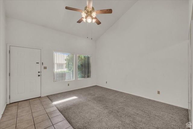entrance foyer featuring ceiling fan, high vaulted ceiling, light carpet, baseboards, and light tile patterned floors