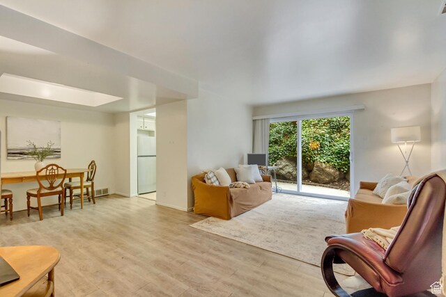 4953 S Eastridge Ln E Unit 143, Salt Lake City, UT 84117 - living area with light wood-style flooring, visible vents, and baseboards