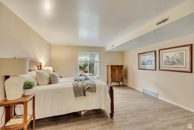 4953 S Eastridge Ln E Unit 143, Salt Lake City, UT 84117 - bedroom featuring baseboards, visible vents, and wood finished floors