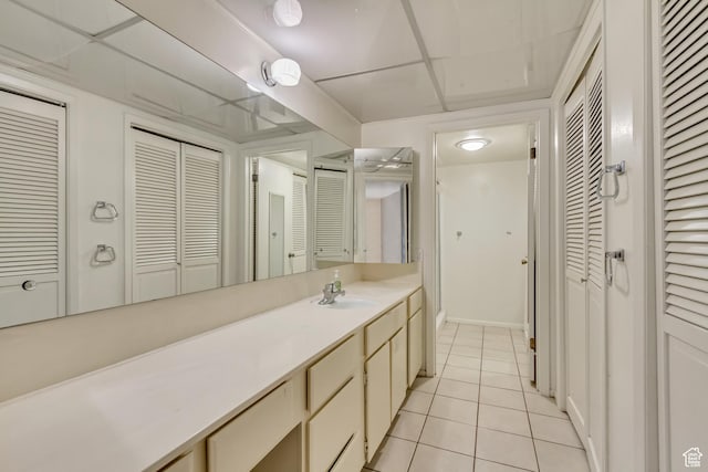 4953 S Eastridge Ln E Unit 143, Salt Lake City, UT 84117 - bathroom with a paneled ceiling, a closet, vanity, and tile patterned floors
