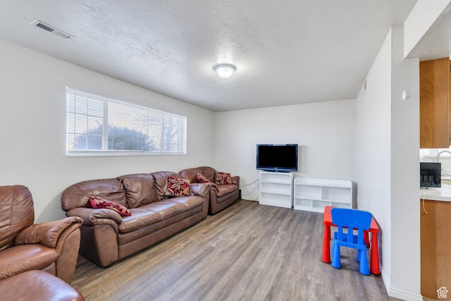 134 N 300 W, Spanish Fork, UT 84660 - living room with a textured ceiling, visible vents, and light wood-style floors
