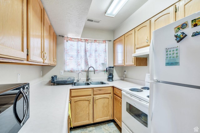 134 N 300 W, Spanish Fork, UT 84660 - kitchen with white appliances, visible vents, light countertops, under cabinet range hood, and a sink