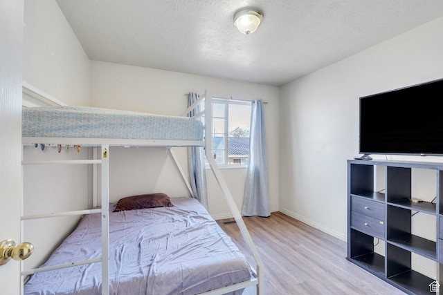 134 N 300 W, Spanish Fork, UT 84660 - bedroom featuring a textured ceiling, wood finished floors, and baseboards