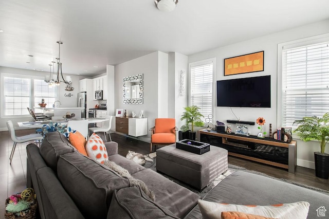 living room featuring dark wood-style floors and baseboards