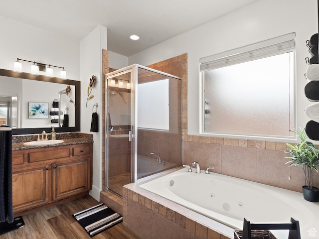 1908 S Yuma Dr, Washington, UT 84780 - full bathroom with a tub with jets, a stall shower, vanity, and wood finished floors
