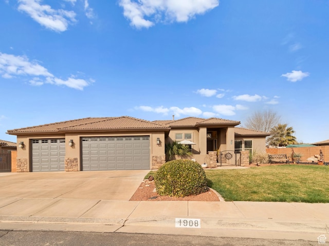 1908 S Yuma Dr, Washington, UT 84780 - view of front of home featuring stone siding, stucco siding, a garage, a tile roof, and driveway