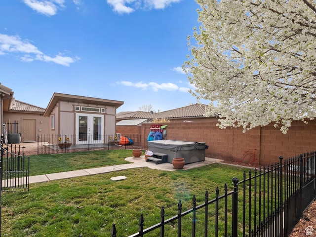 1908 S Yuma Dr, Washington, UT 84780 - fenced backyard with french doors, a hot tub, and a patio