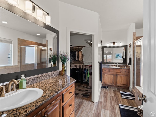 1908 S Yuma Dr, Washington, UT 84780 - full bathroom featuring a stall shower, plenty of natural light, two vanities, and a walk in closet
