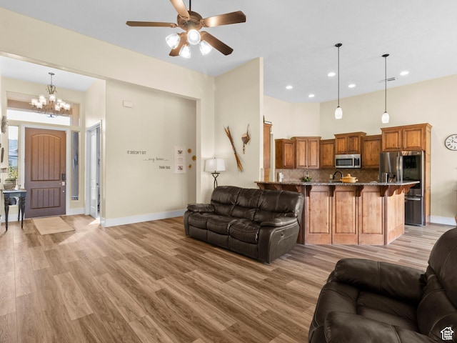 1908 S Yuma Dr, Washington, UT 84780 - living room with light wood finished floors, a ceiling fan, recessed lighting, and a chandelier