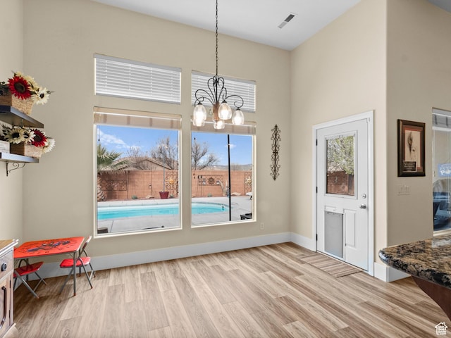 1908 S Yuma Dr, Washington, UT 84780 - dining space featuring wood finished floors, plenty of natural light, a chandelier, and a high ceiling