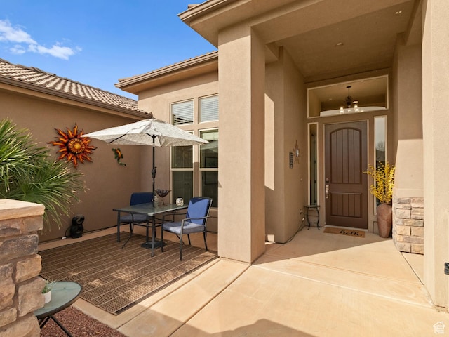 1908 S Yuma Dr, Washington, UT 84780 - property entrance with stucco siding, a patio area, and outdoor dining area
