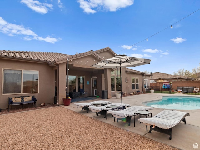 1908 S Yuma Dr, Washington, UT 84780 - back of house with a patio, a tiled roof, and stucco siding