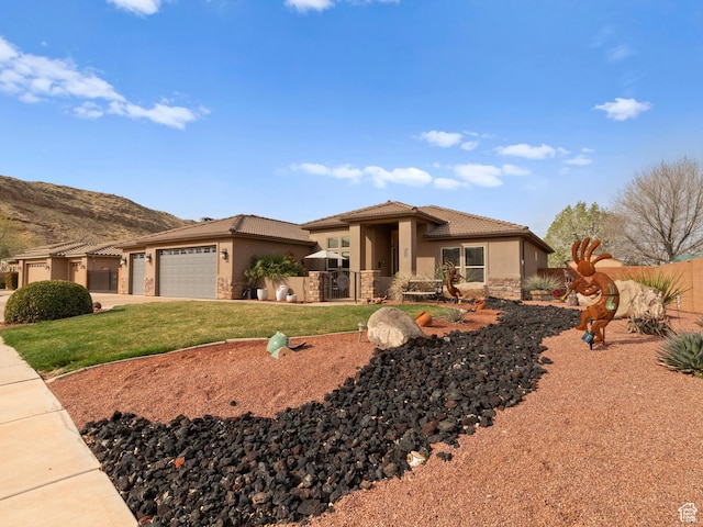 1908 S Yuma Dr, Washington, UT 84780 - view of front facade featuring stone siding, a garage, stucco siding, a tile roof, and driveway