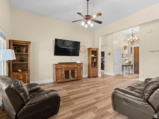1908 S Yuma Dr, Washington, UT 84780 - living area featuring ceiling fan, light wood-style floors, a chandelier, and a towering ceiling