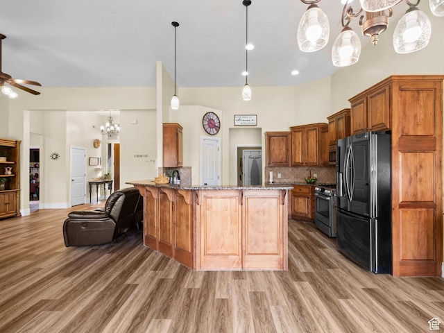 1908 S Yuma Dr, Washington, UT 84780 - kitchen with stainless steel appliances, a chandelier, light wood-style flooring, stone countertops, and ceiling fan