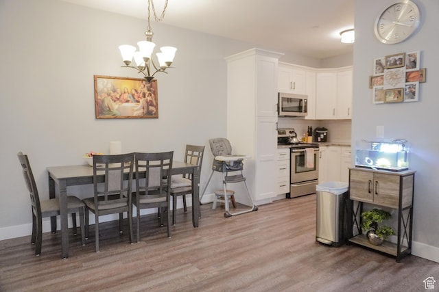 1055 S 500 E Unit D204, Heber City, UT 84032 - dining area with baseboards, a notable chandelier, and light wood finished floors