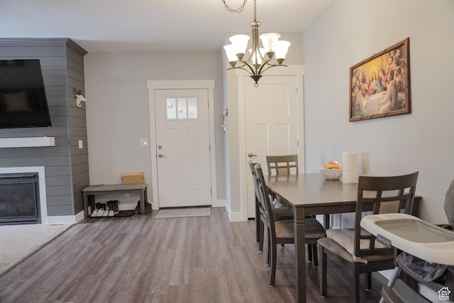 1055 S 500 E Unit D204, Heber City, UT 84032 - dining space featuring a large fireplace, a notable chandelier, baseboards, and wood finished floors