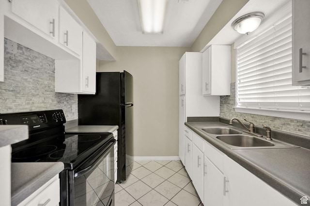 kitchen with dark countertops, black electric range, and white cabinetry