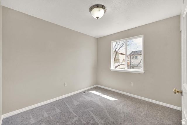 carpeted spare room with baseboards