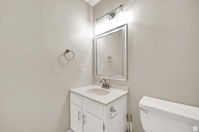 half bath with vanity and toilet