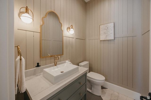 1685 W Midway Ln, Heber City, UT 84032 - bathroom featuring toilet, wood walls, marble finish floor, and vanity