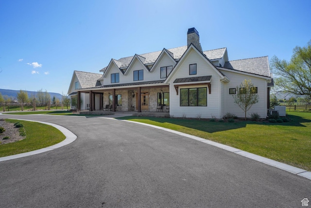 1685 W Midway Ln, Heber City, UT 84032 - modern inspired farmhouse with a chimney, a standing seam roof, metal roof, covered porch, and a front lawn