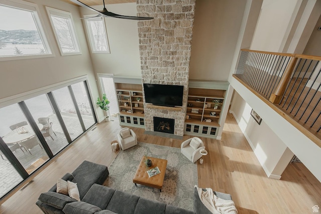 1685 W Midway Ln, Heber City, UT 84032 - living room with ceiling fan, wood finished floors, a towering ceiling, and a fireplace