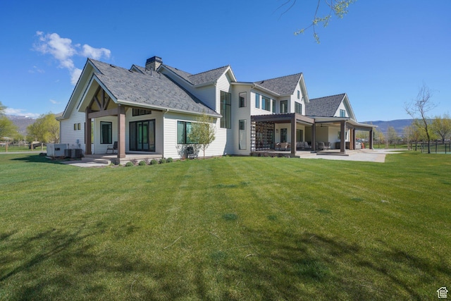 1685 W Midway Ln, Heber City, UT 84032 - rear view of house with a mountain view, a patio, a chimney, and a lawn