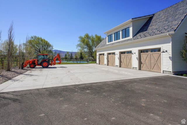 1685 W Midway Ln, Heber City, UT 84032 - view of home's exterior with a mountain view, a garage, fence, a high end roof, and driveway