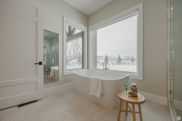 1685 W Midway Ln, Heber City, UT 84032 - full bath featuring tiled shower, a soaking tub, tile patterned floors, visible vents, and baseboards