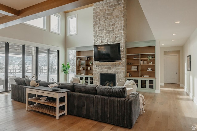 1685 W Midway Ln, Heber City, UT 84032 - living area with high vaulted ceiling, hardwood / wood-style flooring, baseboards, a stone fireplace, and recessed lighting