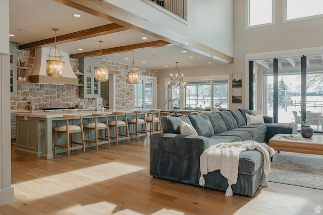 1685 W Midway Ln, Heber City, UT 84032 - living room with light wood-type flooring, plenty of natural light, beamed ceiling, and a notable chandelier