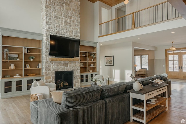 1685 W Midway Ln, Heber City, UT 84032 - living area with a stone fireplace, french doors, a high ceiling, and hardwood / wood-style flooring