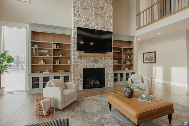 1685 W Midway Ln, Heber City, UT 84032 - living area with a fireplace, a high ceiling, baseboards, and wood finished floors