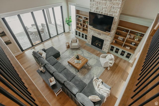 1685 W Midway Ln, Heber City, UT 84032 - living room featuring built in features, wood finished floors, and a fireplace