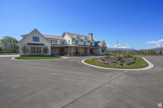 1685 W Midway Ln, Heber City, UT 84032 - view of front of home with covered porch, fence, a mountain view, a chimney, and a standing seam roof