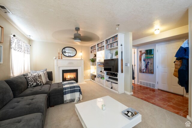 1446 E Murdock Dr S, Pleasant Grove, UT 84062 - living area with a fireplace with flush hearth, visible vents, a textured ceiling, and a ceiling fan