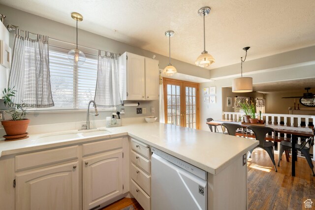 1446 E Murdock Dr S, Pleasant Grove, UT 84062 - kitchen with a peninsula, stainless steel dishwasher, light countertops, and white cabinetry