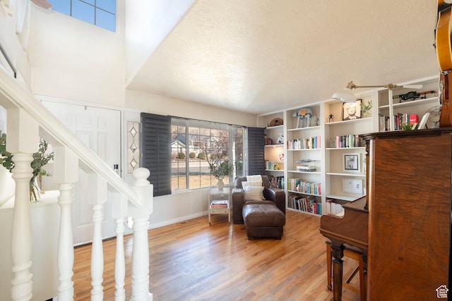 1446 E Murdock Dr S, Pleasant Grove, UT 84062 - living area featuring light wood-style flooring, stairway, and a textured ceiling
