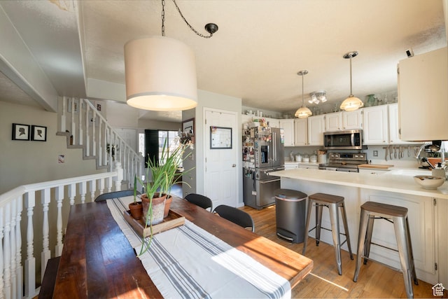 1446 E Murdock Dr S, Pleasant Grove, UT 84062 - dining space with stairway and wood finished floors