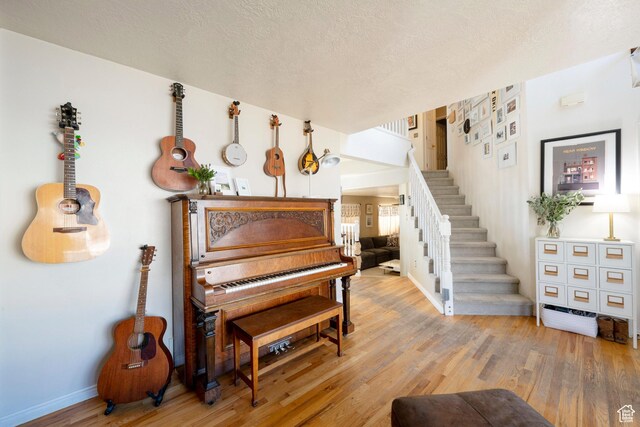 1446 E Murdock Dr S, Pleasant Grove, UT 84062 - sitting room featuring stairs, a textured ceiling, wood finished floors, and baseboards