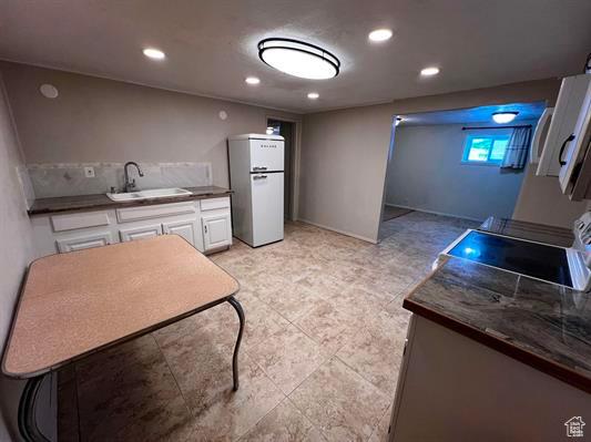404 N 1st E, Grace, ID 83241 - kitchen featuring white cabinets, dark countertops, recessed lighting, a sink, and freestanding refrigerator