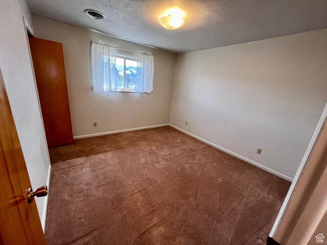 404 N 1st E, Grace, ID 83241 - unfurnished bedroom featuring baseboards, visible vents, and carpet